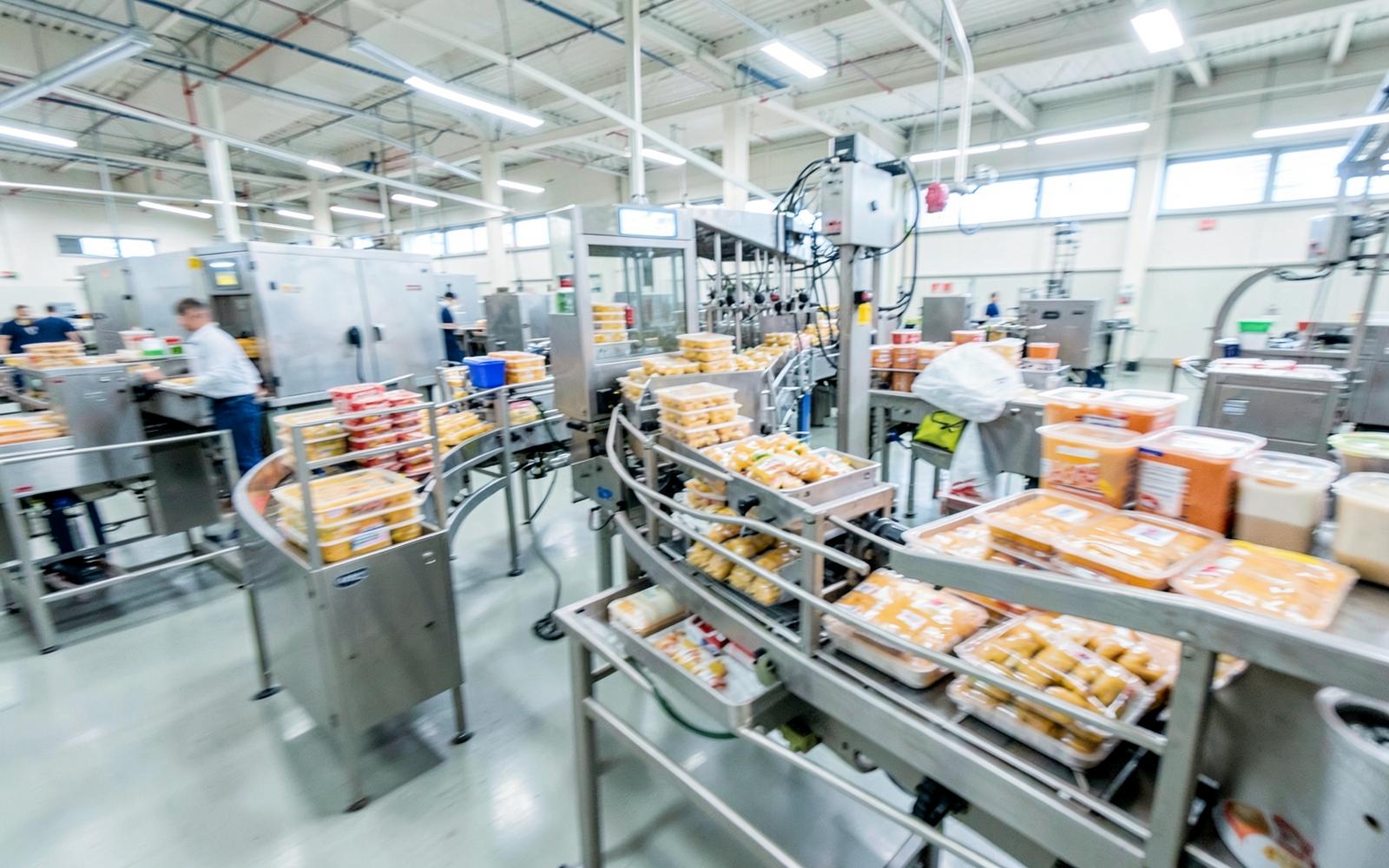 Busy food packaging line with product queued at a line bottleneck